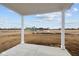 Covered back porch showcasing a view of the neighborhood park and amenities at 1845 James Pierce Dr, Shelbyville, IN 46176