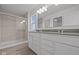 Bathroom with double vanity, a large mirror, tile flooring, and a glass enclosed shower at 1845 James Pierce Dr, Shelbyville, IN 46176