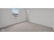 Bright bedroom with carpeted floors and natural light from the window at 1845 James Pierce Dr, Shelbyville, IN 46176
