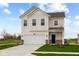 Well-manicured lawn complements the two-story home with a white exterior and a convenient attached garage at 1845 James Pierce Dr, Shelbyville, IN 46176