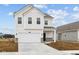 Charming two-story home with a two car garage and manicured front lawn at 1845 James Pierce Dr, Shelbyville, IN 46176