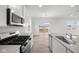 Modern kitchen with stainless steel appliances, an island and open to the living area at 1845 James Pierce Dr, Shelbyville, IN 46176