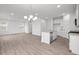 Bright, open-concept room features light-colored floors and a modern chandelier at 1845 James Pierce Dr, Shelbyville, IN 46176