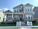 Two-story home with gray siding, brick accents, and a white picket fence at 20027 Old Dock Rd, Westfield, IN 46074