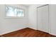 Bright bedroom with hardwood floors and double-door closet at 2250 N Pasadena St, Indianapolis, IN 46219