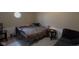 Bedroom with neutral walls, window, bed, and table with lamp at 2301 S Vine St, Muncie, IN 47302