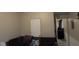 Living room area featuring a dark couch with pillows and view of entryways at 2301 S Vine St, Muncie, IN 47302