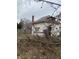 White house with overgrown yard and fence at 2364 Shelby St, Indianapolis, IN 46203