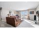 Finished basement with brown leather sectional sofa and large windows at 2449 Lingerman Way, Avon, IN 46123