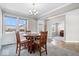 Bright dining room with a round table and four chairs, offering a view of the backyard at 2449 Lingerman Way, Avon, IN 46123