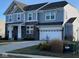 Two-story house with gray and blue siding, a brick facade, and a three-car garage at 2449 Lingerman Way, Avon, IN 46123