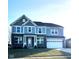 Two-story home with gray and blue siding, brick accents, and a three-car garage at 2449 Lingerman Way, Avon, IN 46123