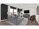 Bright living room features gray sofas, a wood coffee table, and an accent chair at 2773 Linwood Ave, Greenwood, IN 46143