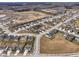 Aerial view of homes in a suburban neighborhood with a pond in the distance at 4201 Risen Star Way, Bargersville, IN 46106