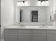 Clean bathroom with double vanity and large mirror at 4201 Risen Star Way, Bargersville, IN 46106