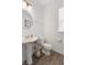 Clean bathroom with pedestal sink, toilet, and wood-look flooring at 4201 Risen Star Way, Bargersville, IN 46106