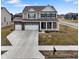 Inviting two-story home with a three-car garage, manicured lawn, and charming front porch at 4201 Risen Star Way, Bargersville, IN 46106