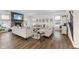 Spacious living room with stone fireplace, hardwood floors, and ample seating at 4201 Risen Star Way, Bargersville, IN 46106