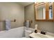 Cozy bathroom features wood accents, decorative mirror, and modern fixtures at 4814 Oakwood Trl, Indianapolis, IN 46268