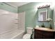 Bright bathroom with a shower and tub combination plus vanity and decorative mirror at 4814 Oakwood Trl, Indianapolis, IN 46268