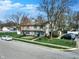 A daytime, elevated view of the two-story home featuring a lawn and mature trees at 4814 Oakwood Trl, Indianapolis, IN 46268