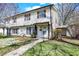 Two-story home features a walkway leading to the front door, complemented by healthy, green lawns at 4814 Oakwood Trl, Indianapolis, IN 46268
