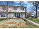 Charming two-story home with white siding and decorative shutters and landscaping at 4814 Oakwood Trl, Indianapolis, IN 46268