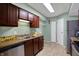 Modern kitchen features stainless steel appliances, tile floors, and ample cabinet space at 4814 Oakwood Trl, Indianapolis, IN 46268