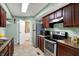 Kitchen features stainless steel appliances, tile floors, and ample cabinet space at 4814 Oakwood Trl, Indianapolis, IN 46268