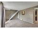 Bright living room features carpeted floors, white stairs, and natural light at 4814 Oakwood Trl, Indianapolis, IN 46268