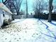 A fenced backyard, offering privacy, and is lightly covered in snow at 4818 E 14Th St, Indianapolis, IN 46201