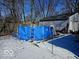 Backyard featuring an above ground pool surrounded by a snow-covered yard at 4818 E 14Th St, Indianapolis, IN 46201