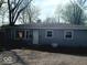 Quaint single-story home with a gravel driveway and a neatly landscaped front yard at 4818 E 14Th St, Indianapolis, IN 46201