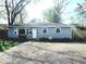 Charming single-story home with a gravel driveway and a well-maintained front yard at 4818 E 14Th St, Indianapolis, IN 46201