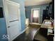 View of a kitchen showcasing white cabinets, stainless appliances, and dark wood floors at 4818 E 14Th St, Indianapolis, IN 46201