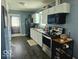 Well-lit kitchen with white cabinetry, stainless steel appliances, and dark wood floors at 4818 E 14Th St, Indianapolis, IN 46201