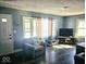 Cozy living room with a comfortable armchair, dark floors and lots of natural light at 4818 E 14Th St, Indianapolis, IN 46201