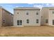 Exterior view of the home's rear showcases the siding, windows, and sliding glass door at 5123 Rolling Meadow Blvd, Indianapolis, IN 46237