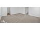 Spacious bedroom with neutral carpet and a view of the bathroom and hallway at 5123 Rolling Meadow Blvd, Indianapolis, IN 46237