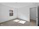 Bedroom features a large window, neutral carpet, and neutral walls, offering a bright and airy space at 5123 Rolling Meadow Blvd, Indianapolis, IN 46237