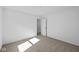 Minimal bedroom features neutral carpeting and an open doorway, creating a simple and calming aesthetic at 5123 Rolling Meadow Blvd, Indianapolis, IN 46237