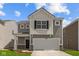 Charming two-story home with gray siding, white accents, and an attached two-car garage at 5123 Rolling Meadow Blvd, Indianapolis, IN 46237