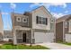 Inviting two-story home featuring gray siding, white trim, and a convenient two-car garage at 5123 Rolling Meadow Blvd, Indianapolis, IN 46237