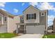 Attractive two-story house with gray siding, white trim, and an integrated two-car garage at 5123 Rolling Meadow Blvd, Indianapolis, IN 46237