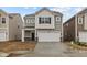 Charming two-story home features a two-car garage, covered entry, and stone accents at 5123 Rolling Meadow Blvd, Indianapolis, IN 46237