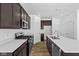 Updated kitchen with modern appliances, quartz countertops, and stylish dark wood cabinetry at 5123 Rolling Meadow Blvd, Indianapolis, IN 46237
