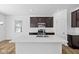 Modern kitchen with stainless steel appliances, quartz countertops, and ample cabinet space at 5123 Rolling Meadow Blvd, Indianapolis, IN 46237
