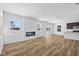 Spacious living room with a modern fireplace, hardwood floors, and access to the dining area at 5123 Rolling Meadow Blvd, Indianapolis, IN 46237