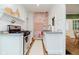 White kitchen with exposed brick and granite countertops at 5164 Guilford Ave, Indianapolis, IN 46205