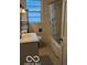 Bathroom with a tub shower, sink, and patterned flooring at 5414 E 11Th St, Indianapolis, IN 46219